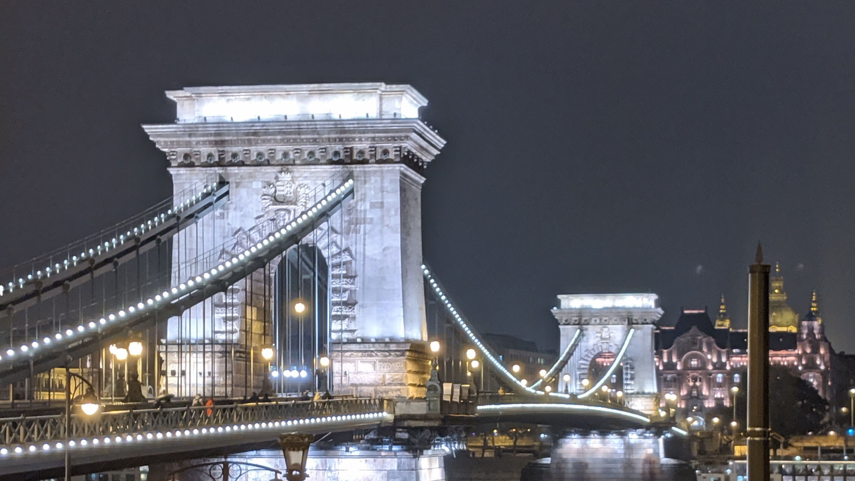 The Chain Bridge in Budapest lit up at night.